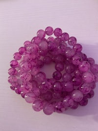 pink jade beads on a white surface