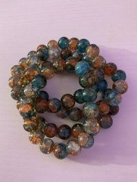 a bracelet with blue, orange and brown beads