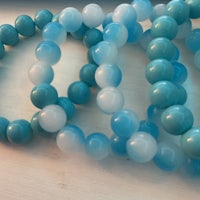 a group of blue and white beads on a table