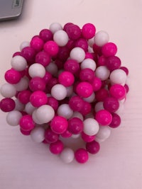 pink and white beads stacked on top of each other