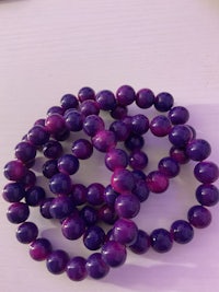 purple and purple beads stacked on top of each other