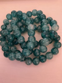 green agate beads on a white wall